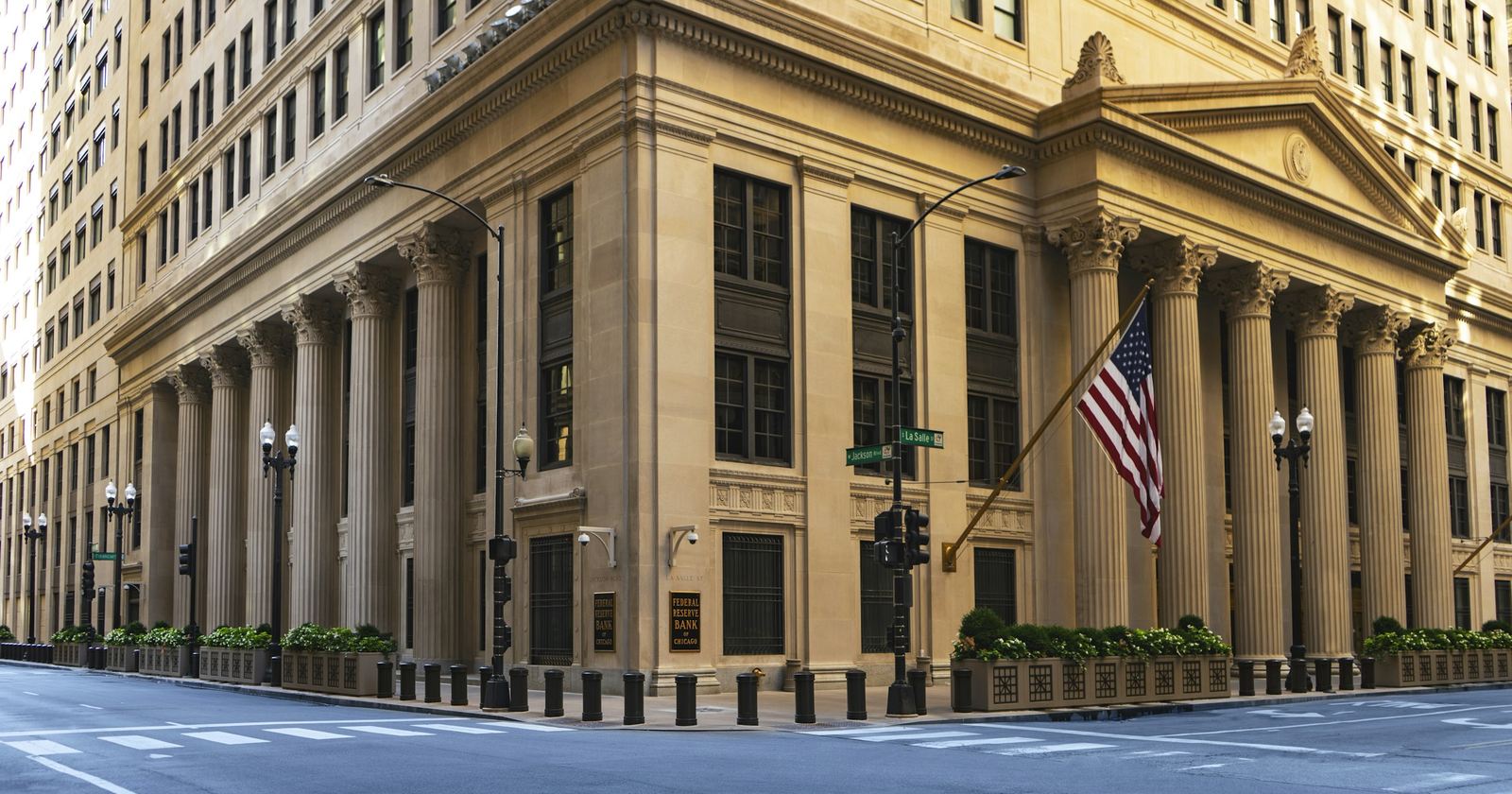 A large columned building with a flag flying at its corner