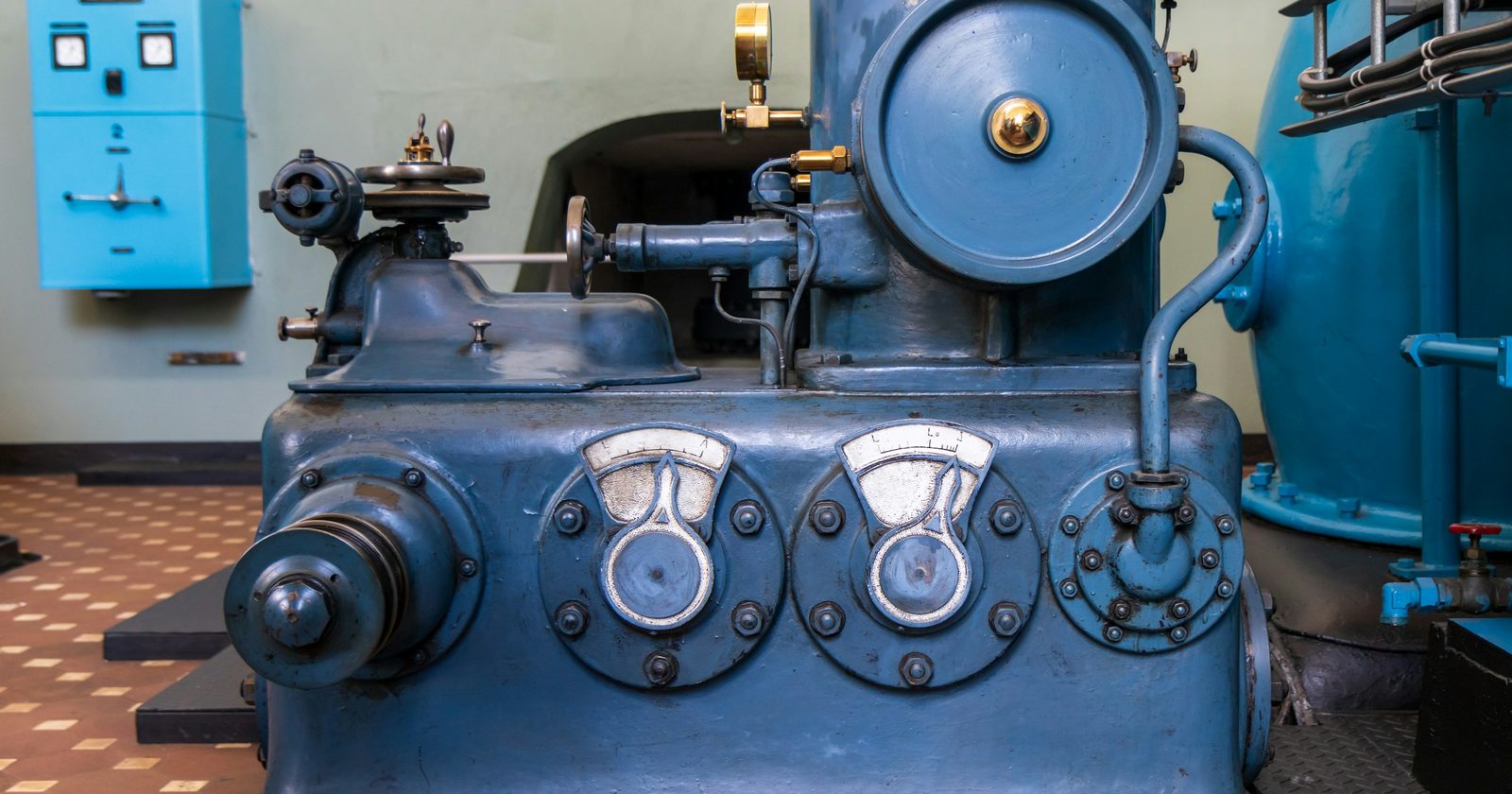 A large blue industrial machine standing inside a plant, the kind of asset whose credit accumulates