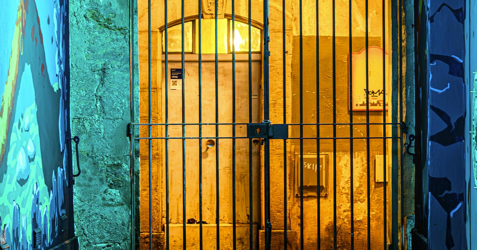 A gated doorway lit from within at night — the supply that arrives with no invoice at all