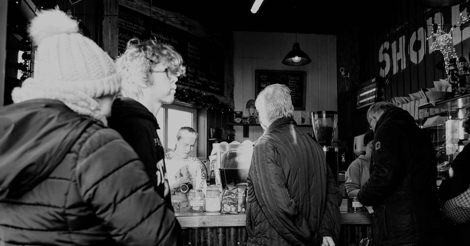 People gathered at the counter of a small business