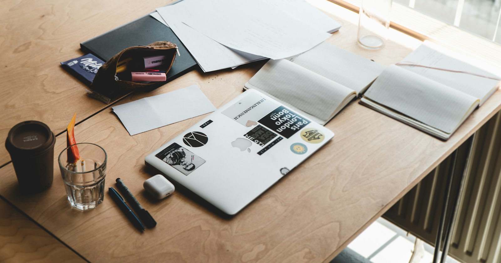 A laptop open on a bare wooden desk