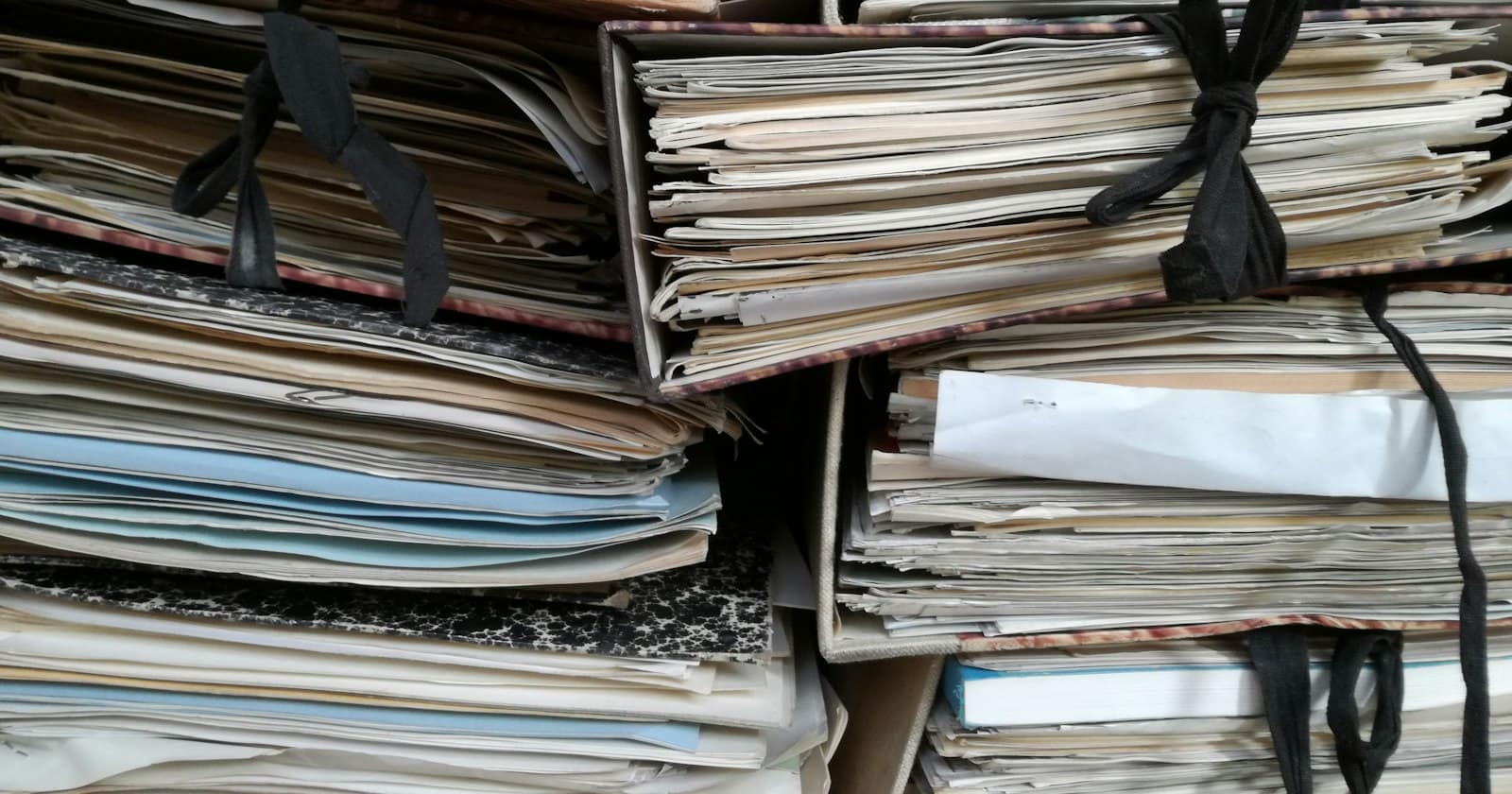 Stacks of paper files tied with string
