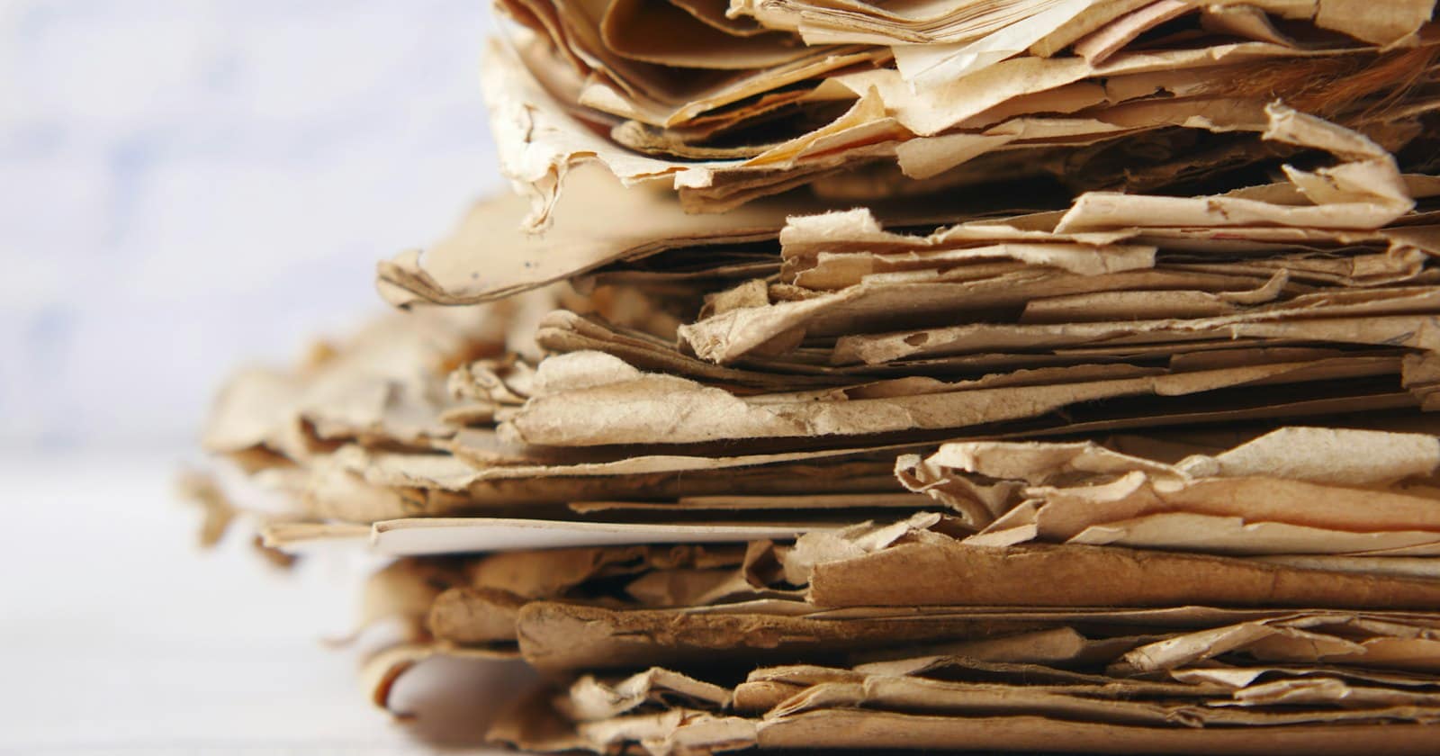 A tall pile of old paper records